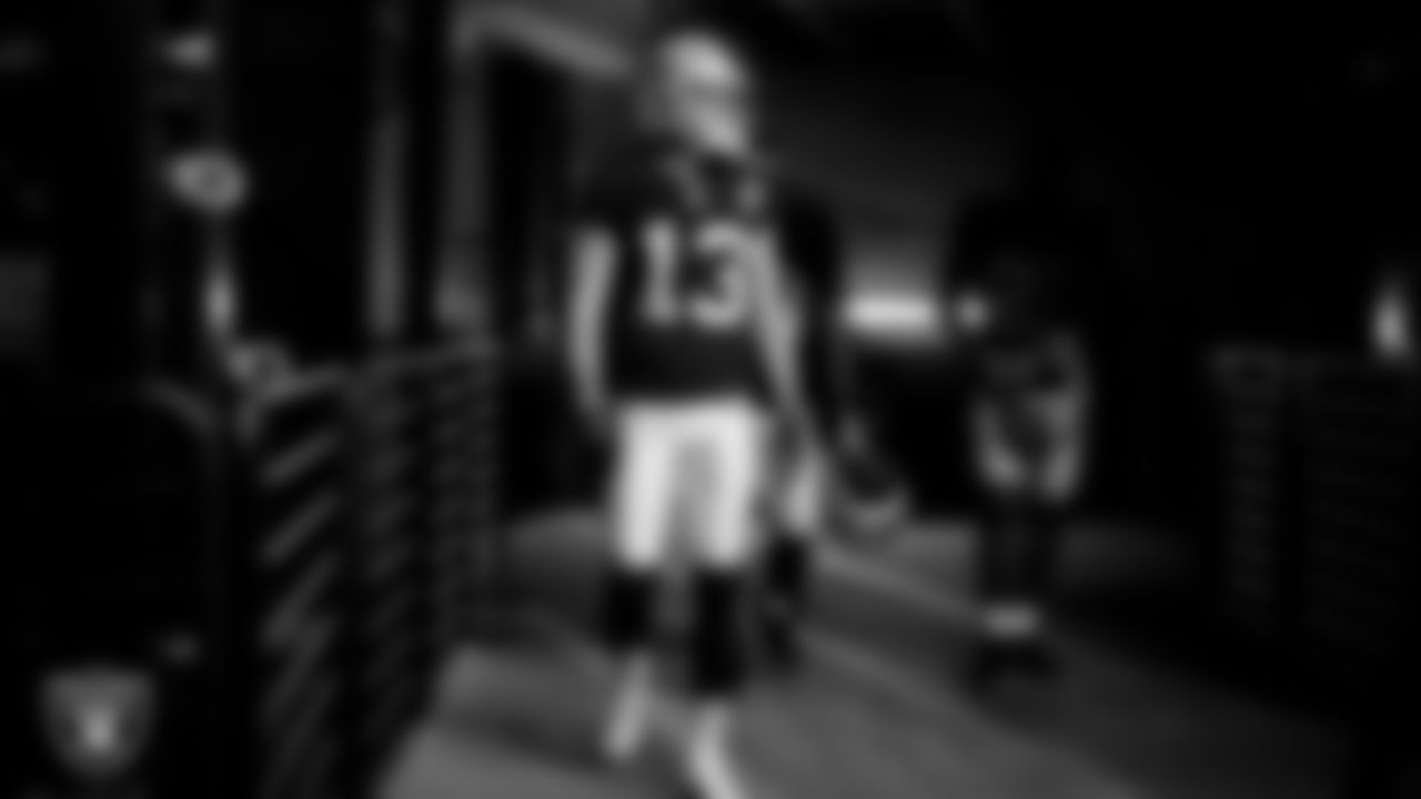 The Raiders walk down the tunnel before the regular season game against the Denver Broncos at Allegiant Stadium.