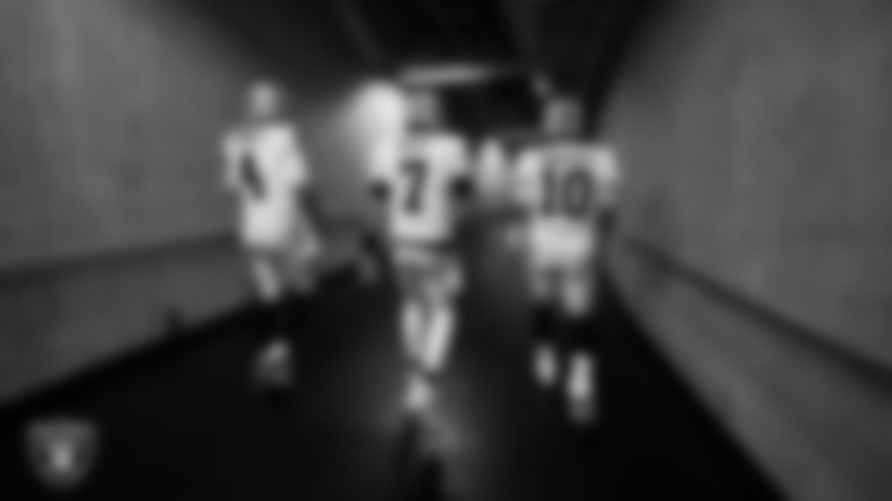 Las Vegas Raiders quarterbacks Aidan O'Connell (4), Brian Hoyer (7) and Jimmy Garoppolo (10) walk down the tunnel before the regular season away game against the Detroit Lions at Ford Field.