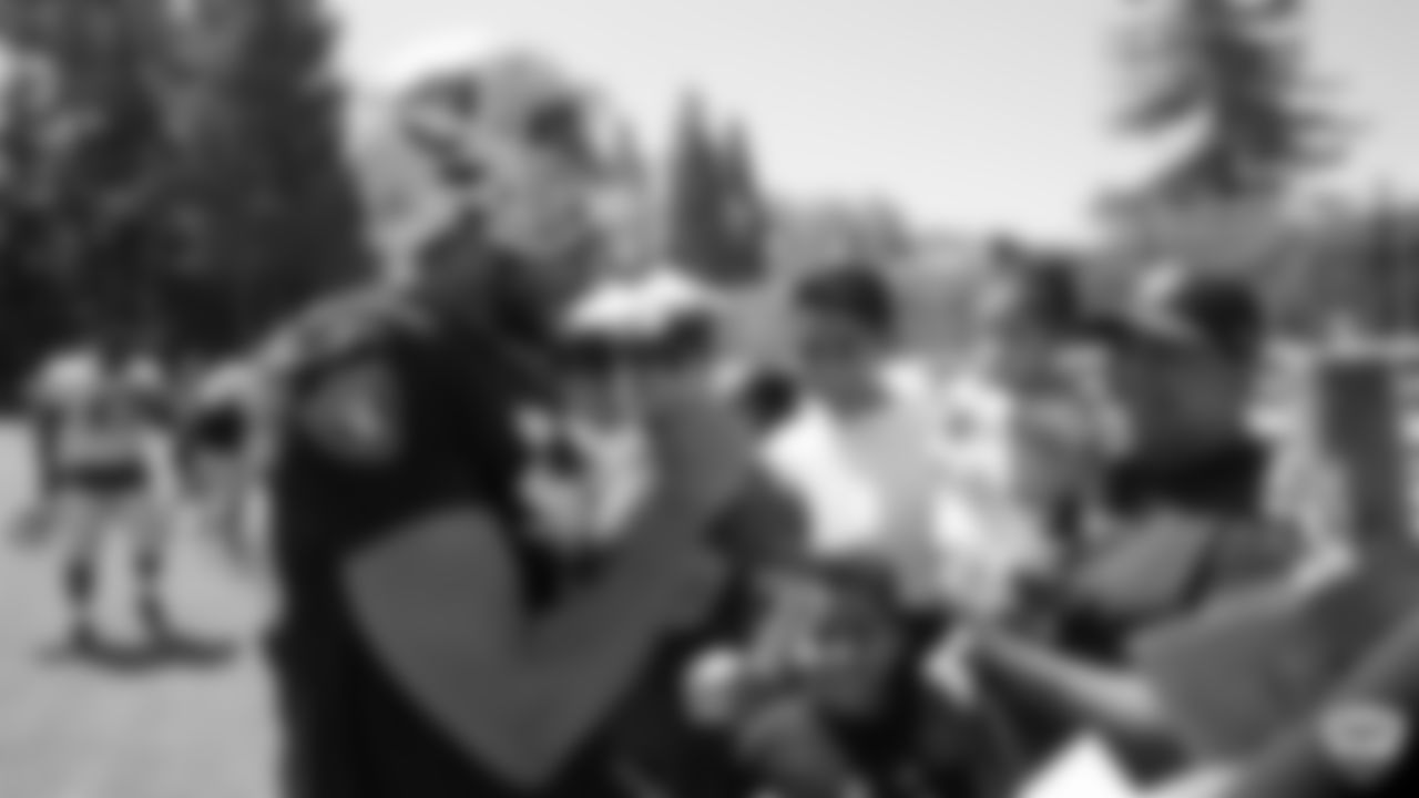Raiders linebacker Kyle Wilber (58) signs autographs for fans after practice at 2019 Training Camp.