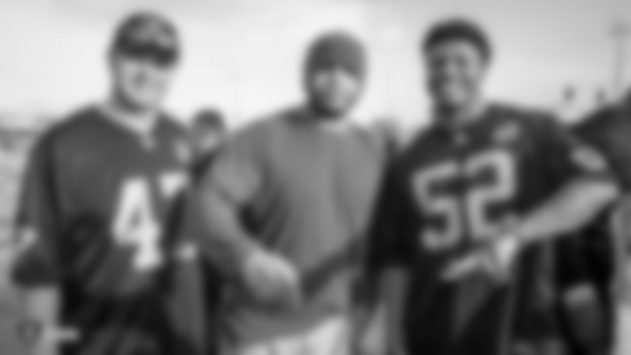 Raiders long snapper Trent Sieg (47) and linebacker Marquel Lee (52) pose for a photo with a construction worker following an official announcement of the Raiders changing their name to the Las Vegas Raiders.