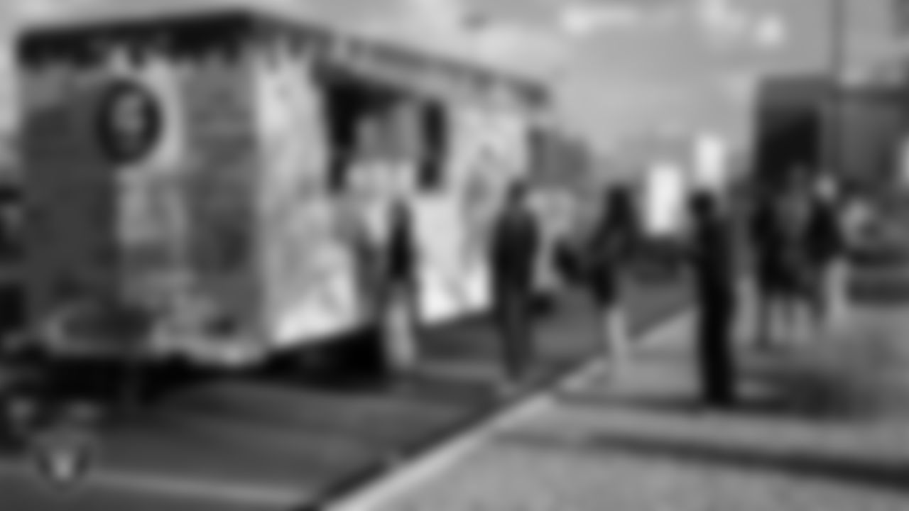 Guests line up for to order from a food truck during the P.A.C.E. kickoff event at Las Vegas Raiders Headquarters, Thursday, May 18, 2023, in Henderson, Nev.