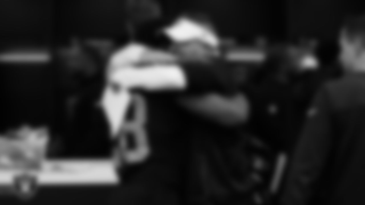 Las Vegas Raiders running back Josh Jacobs (28) and Head Coach Josh McDaniels hug in the locker room after the regular season home game against the Los Angeles Chargers at Allegiant Stadium.