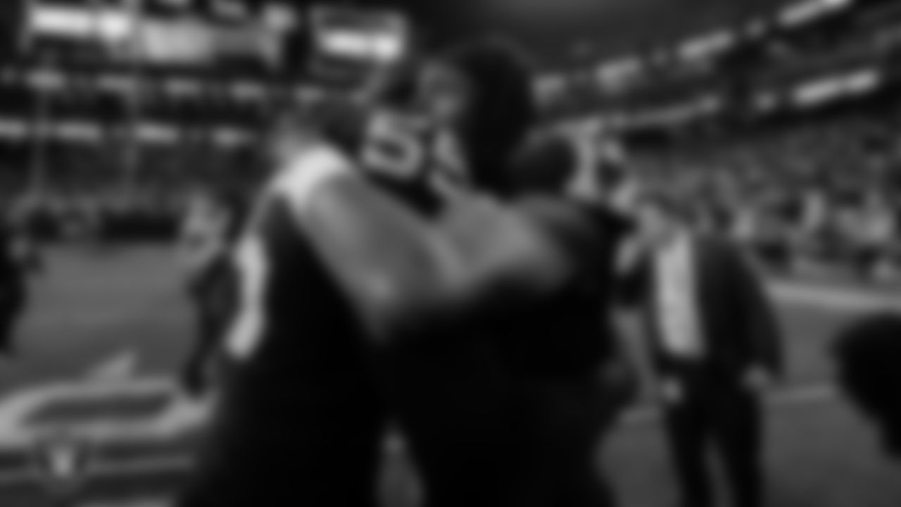 Las Vegas Raiders defensive end Chandler Jones (55) and wide receiver Davante Adams (17) on the field after the regular season home game against the New England Patriots at Allegiant Stadium.