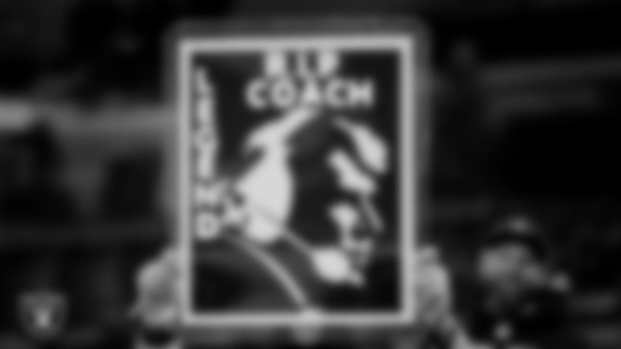 A fan holds a sign in honor of John Madden before the Las Vegas Raiders' regular season away game against the Indianapolis Colts.