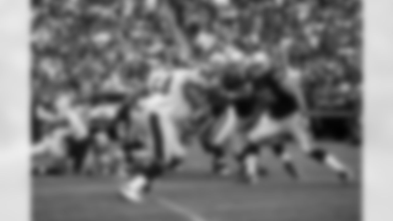 The offensive line blocks for QB Carson Palmer.