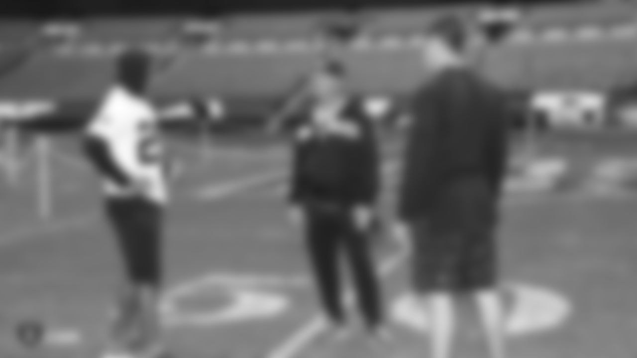 Oakland Raiders cornerback Leon Hall (29), head coach Jon Gruden, and quarterback Derek Carr (4) on the field for a walk through before their game against the Seattle Seahawks, Saturday, October 13, 2018, in London, England.