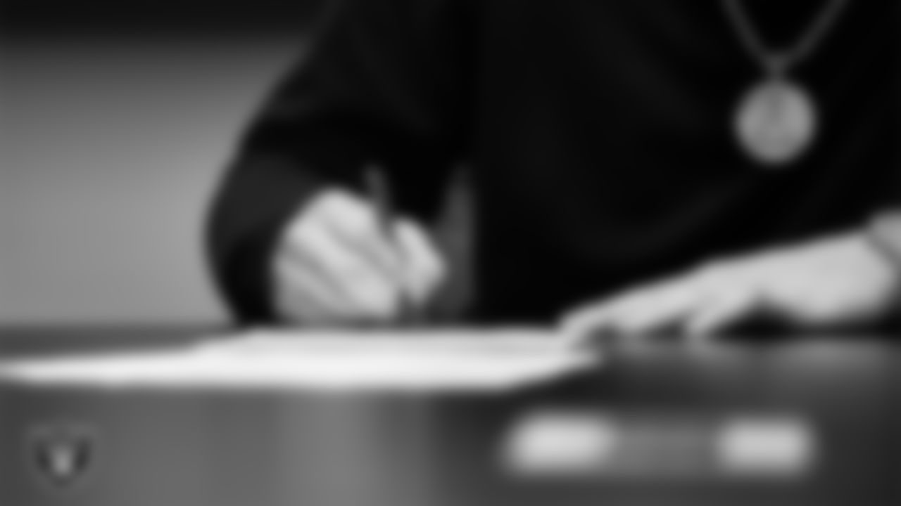 Las Vegas Raiders defensive end Maxx Crosby signs a contract extension.