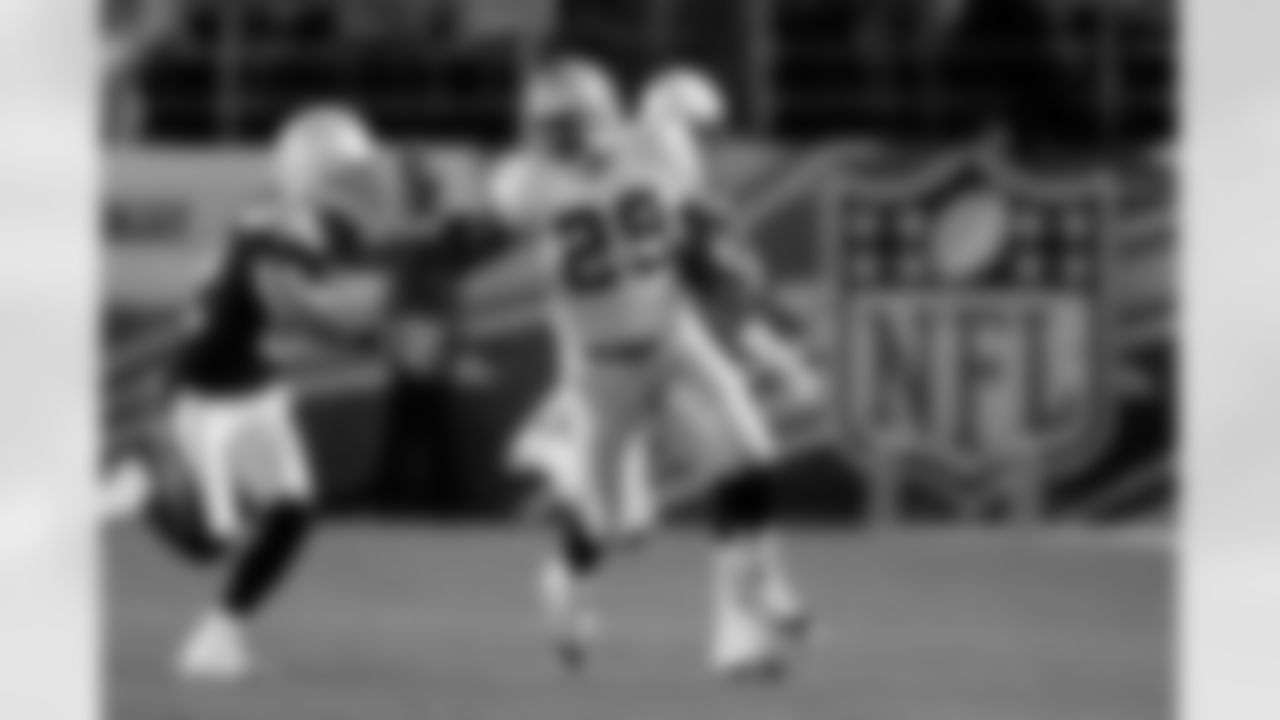 RB Michael Bush sticks out his arm to fend off the defender.