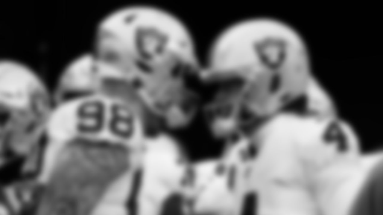 Las Vegas Raiders defensive end Maxx Crosby (98) and quarterback Derek Carr (4) wait to take the field before the postseason away game against the Cincinnati Bengals.