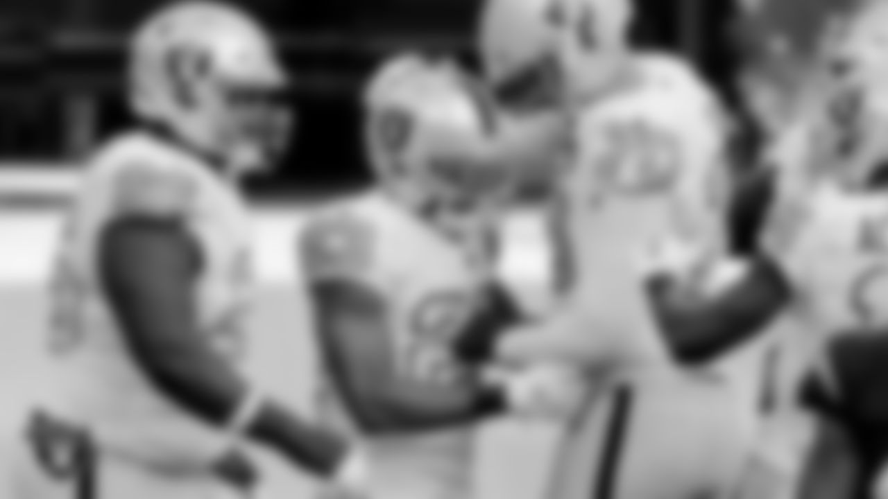 Las Vegas Raiders running back Devontae Booker (23) celebrates with guard Gabe Jackson (66) and tackle Sam Young (70) after rushing for a 23-yard touchdown during the regular season away game against the Los Angeles Chargers.