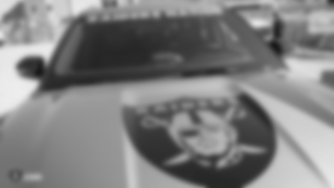 A Ford vehicle with Raiders decals is displayed at a private event celebrating Desert Ford Dealers' new partnership with Allegiant Stadium and the Raiders.