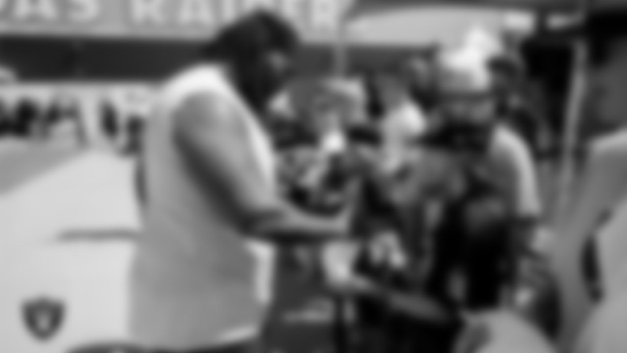 Las Vegas Raiders defensive tackle John Jenkins (95) signs autographs for fans after practice at 2023 Training Camp at Intermountain Health Performance Center.