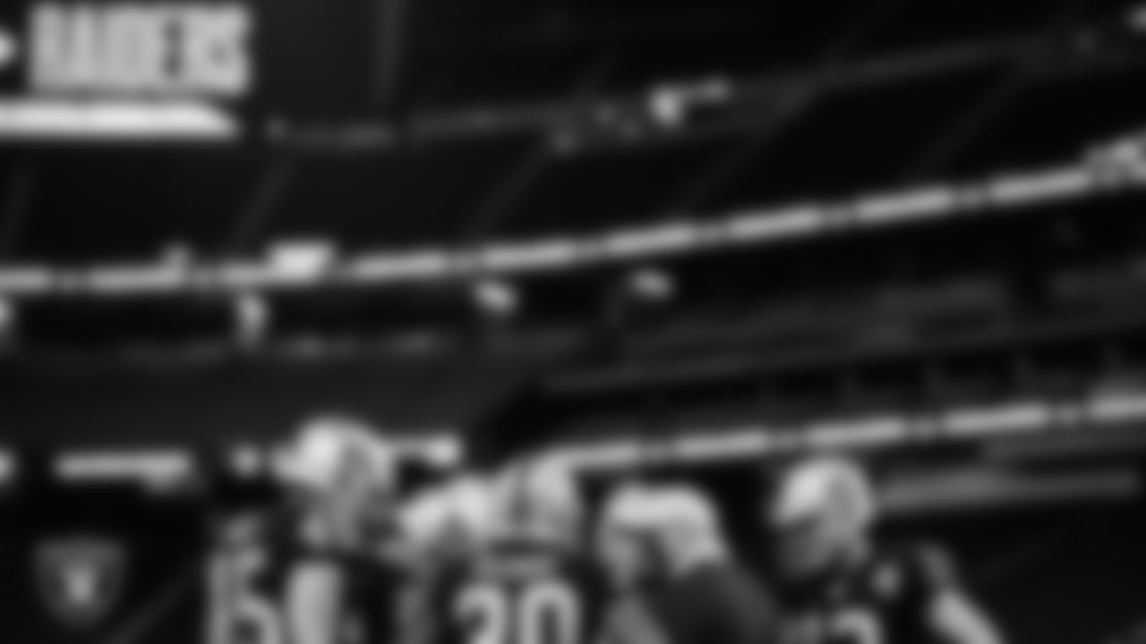 The Las Vegas Raiders huddle before the regular season home game against the Los Angeles Chargers.
