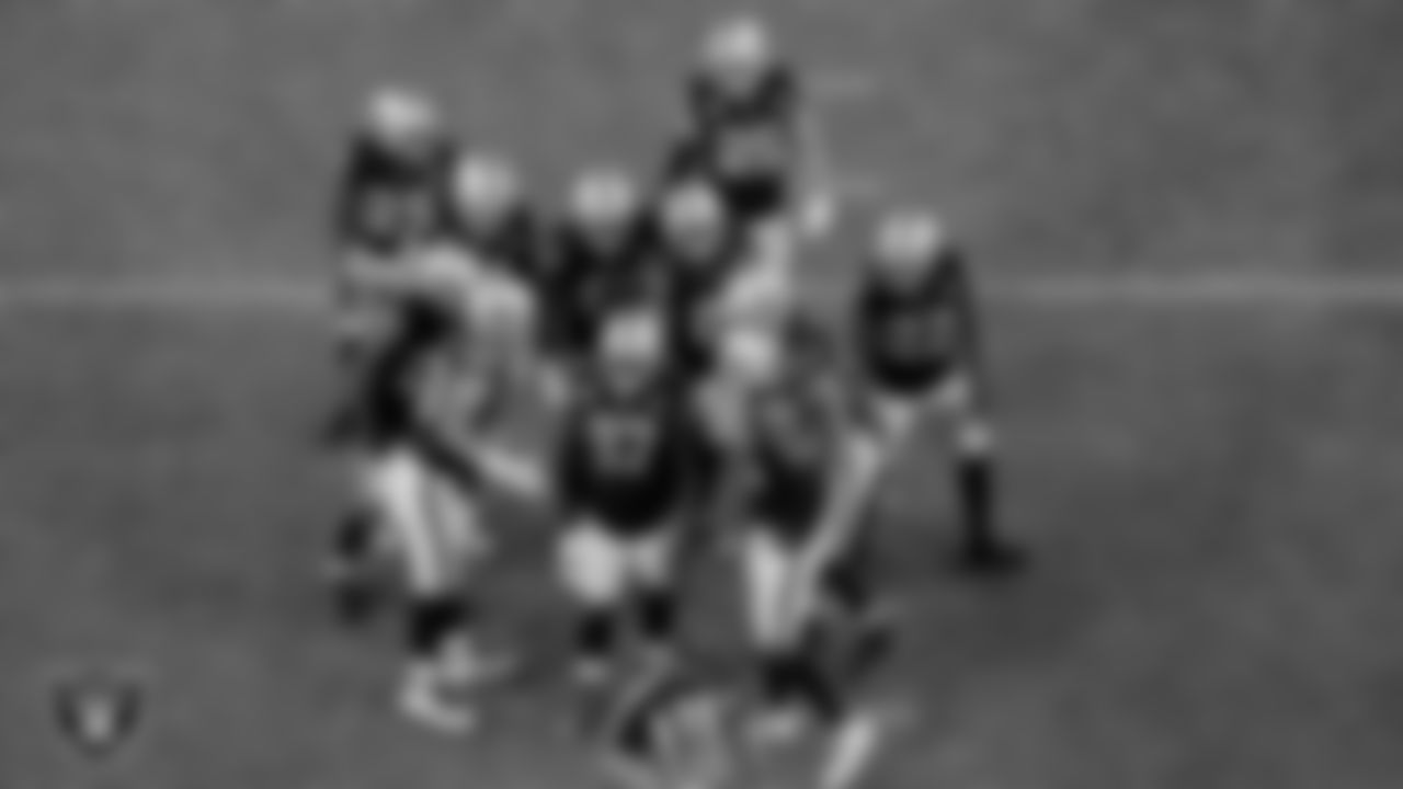 The Las Vegas Raiders defense huddles during the regular season game against the Denver Broncos at Allegiant Stadium.