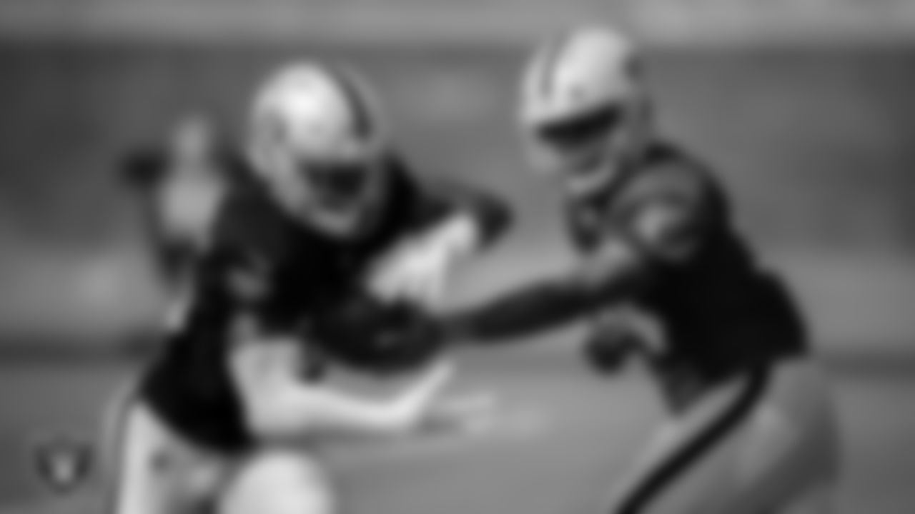 Las Vegas Raiders running back Theo Riddick (35) and quarterback DeShone Kizer (14) during practice.