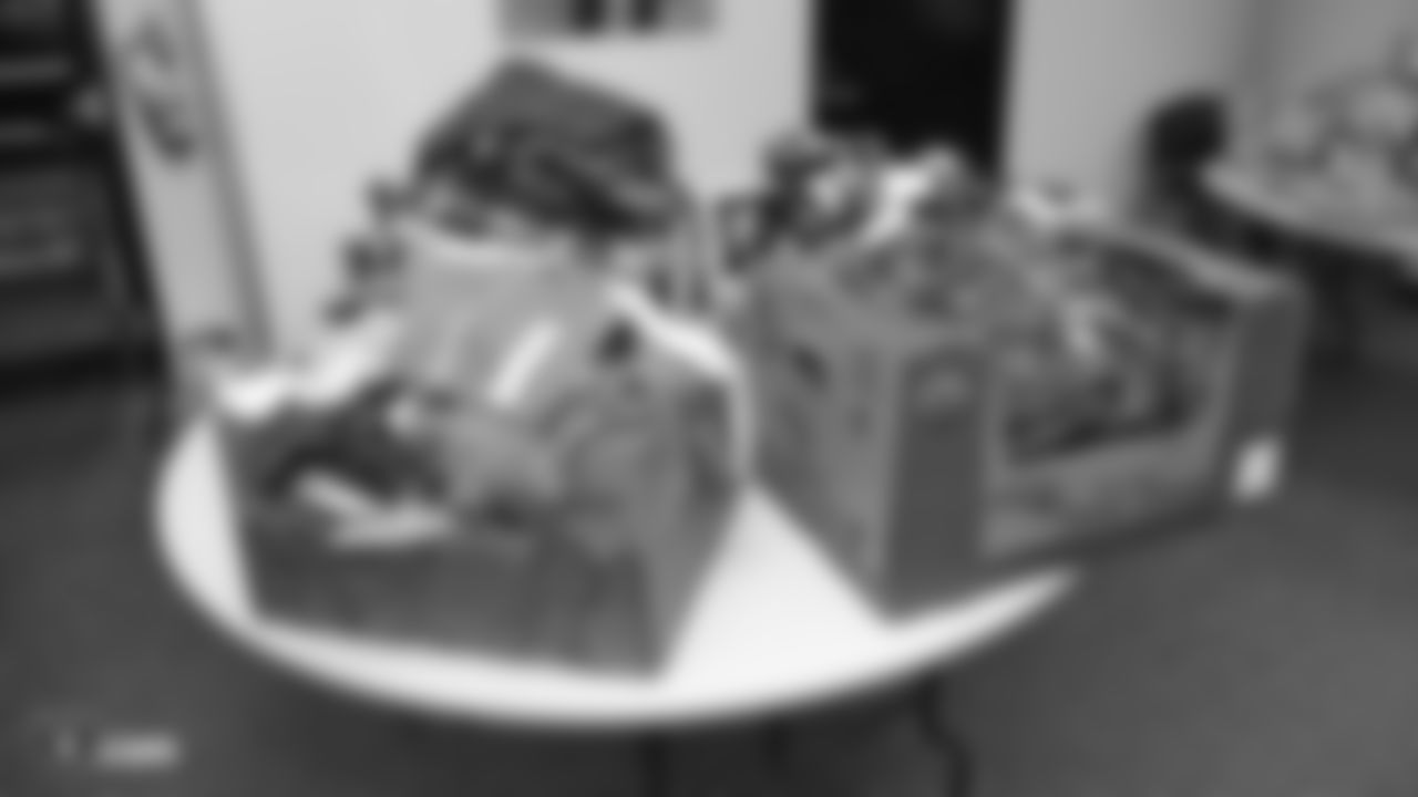 Oakland Raiders linebacker Kyle Wilber (58), tight end Paul Butler (84), tackle Jamar McGloster (64), defensive tackle Clinton McDonald (97), linebacker Shilique Calhoun (91), long snapper Andrew DePaola (48), the Raiderettes, and the Raiders Front Office in Alameda build care packages for victims of the Norther California Fires, Tuesday, November 20, 2018, in Alameda, California.