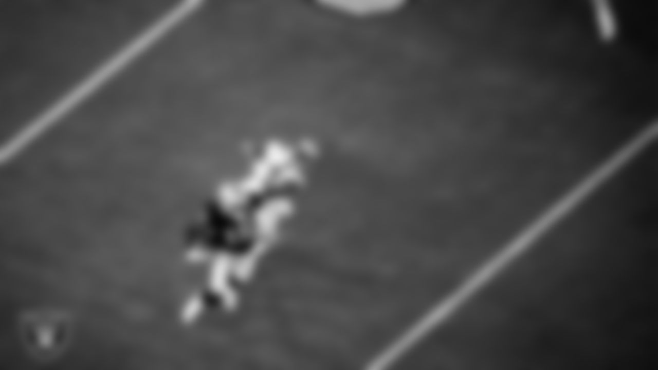 Las Vegas Raiders wide receiver Nelson Agholor (15) stiff arms the defender during the regular season home game against the New Orleans Saints.