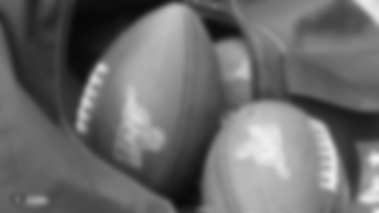 Raiders footballs on the field for a preseason practice.