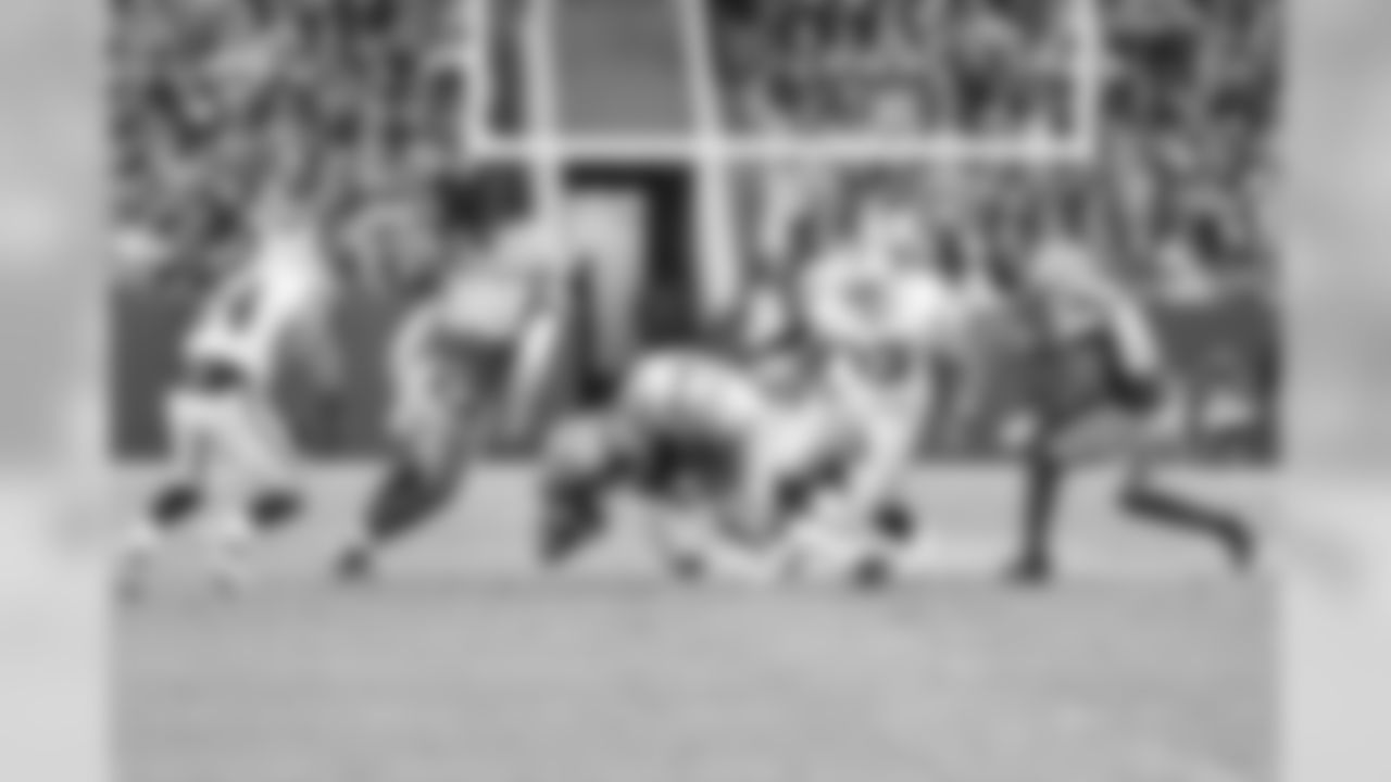 Safety Matt Giordano tackles Packers RB Ryan Grant.