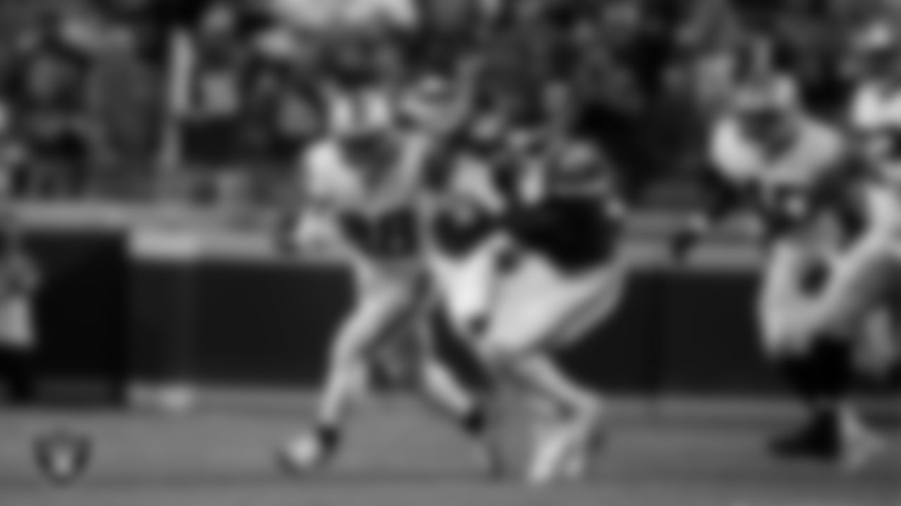 Las Vegas Raiders running back Josh Jacobs (28) stiff arms the defender during the regular season away game against the Kansas City Chiefs at GEHA Field at Arrowhead Stadium.