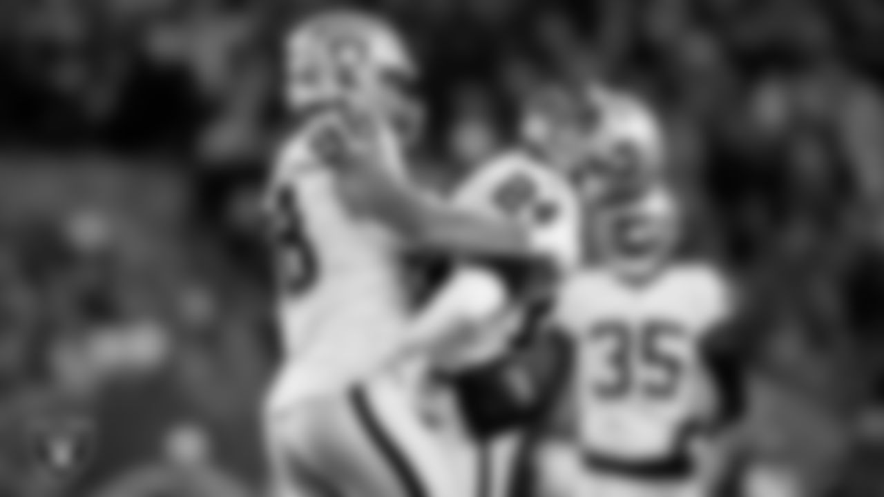 Las Vegas Raiders safety Johnathan Abram (24) is congratulated by defensive end Maxx Crosby (98) after making a tackle during the regular season away game against the Cleveland Browns.