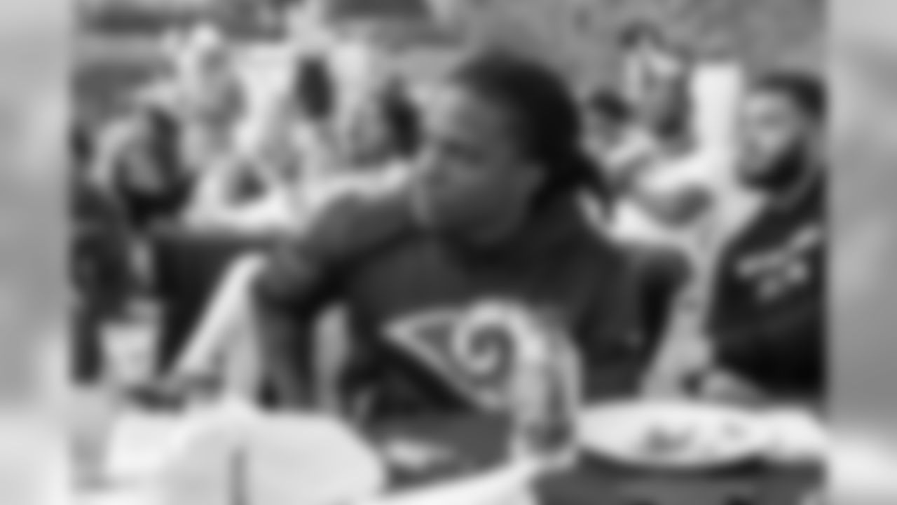 Wide receiver (14) Nsimba Webster of the Los Angeles Rams listens to HOF running back Eric Dickerson and (30) Todd Gurley speak to the rookies at a BBQ/Social at Eric Dickerson's home, Tuesday, June 11, 2019, in Calabasas, CA. (Jeff Lewis/Rams)