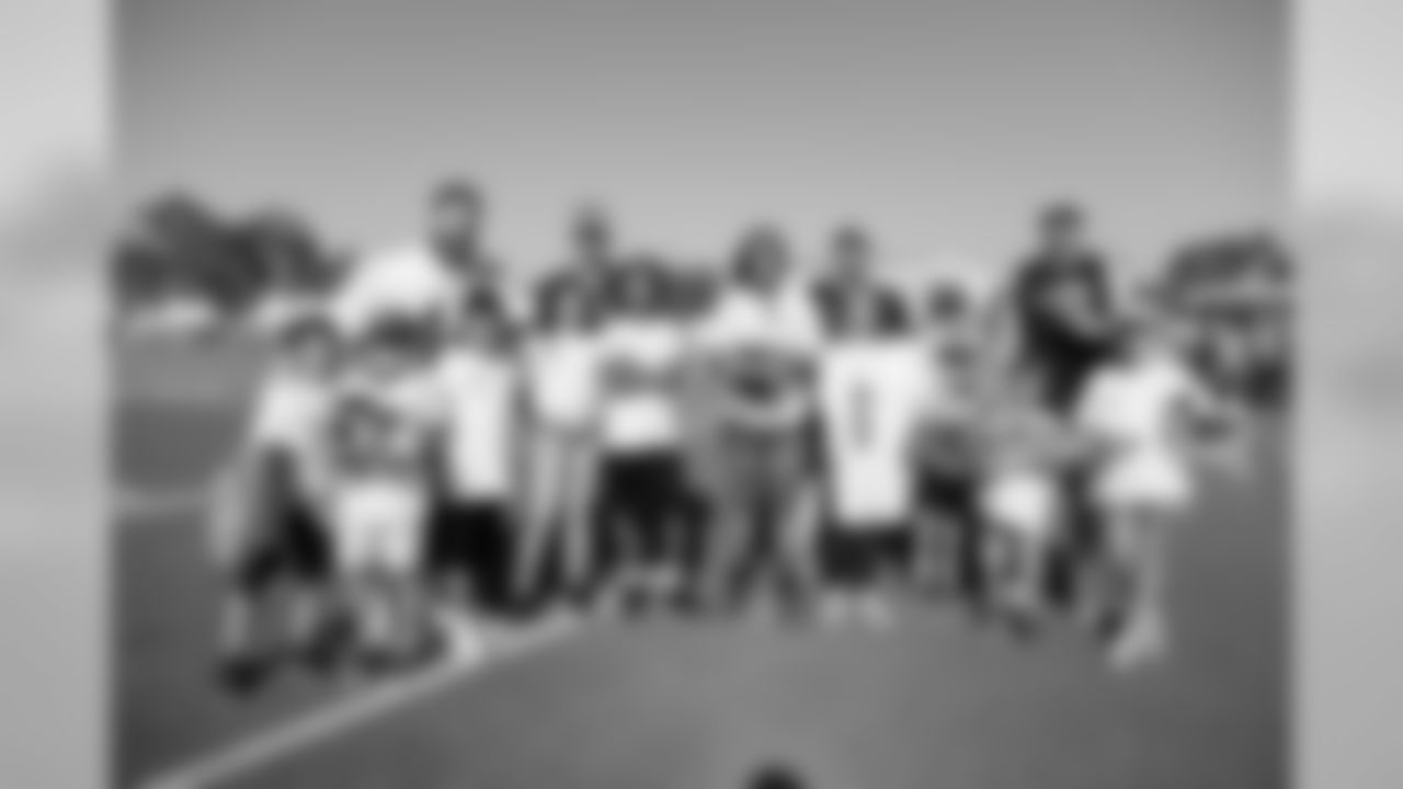 Los Angeles Rams players Punter (06) Johnny Hekker, Long Snapper (44) Jake McQuaide, Kicker (04) Greg Zuerlein, and Kicker (05) Sam Ficken pose with Helpful Honda Rookie fans for a group photo during Day 1 of Training Camp, Thursday, July 26, 2018, in Irvine, CA. (Will Navarro/Rams)