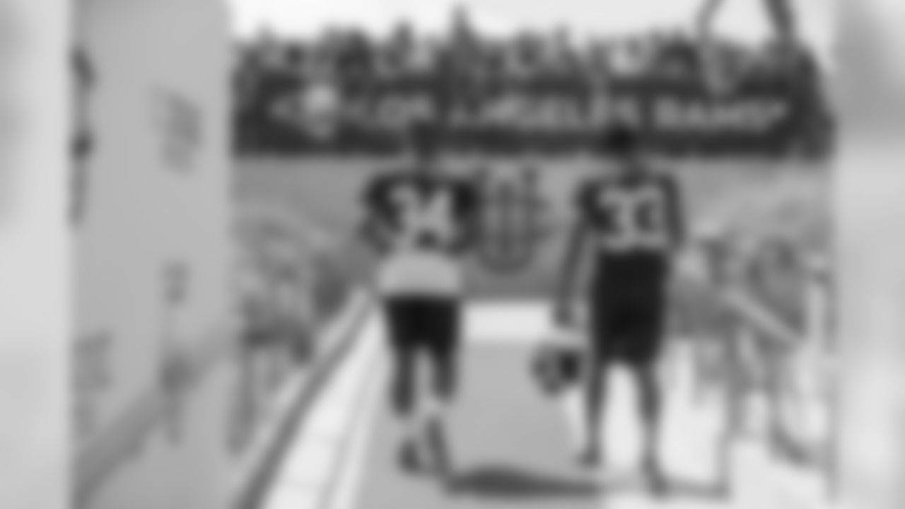 Running backs (34) Malcolm Brown and (33) Justin Davis of the Los Angeles Rams walk out to the practice field on Day 3 of Training Camp, Saturday, July 28, 2018, in Irvine, CA. (Jeff Lewis/Rams)