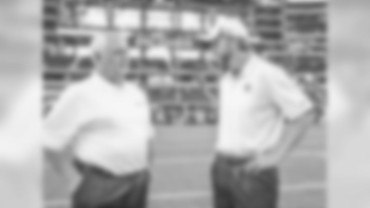 Dallas Cowboys tight ends coach Wes Phillips (right) talks with his dad, Houston Texans defensive coordinator, Wade Phillips (left) before an NFL preseason football game on Thursday, August 29, 2013, at AT&T Stadium in Arlington, Texas. The Texans defeated the Cowboys, 24-6. (AP Photo/James D. Smith)