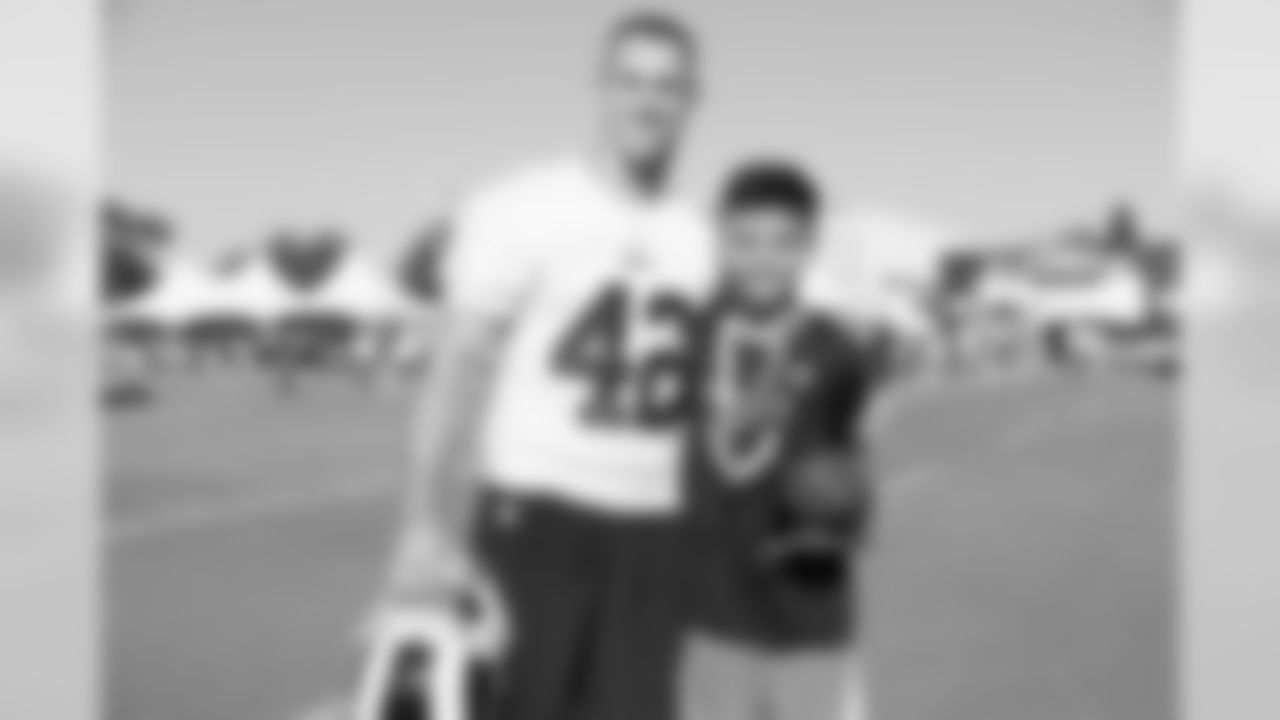 Safety (42) Nate Holley of the Los Angeles Rams poses for a photo with a fan during Day 3 of Training Camp, Saturday, July 28, 2018, in Irvine, CA. (Will Navarro/Rams)