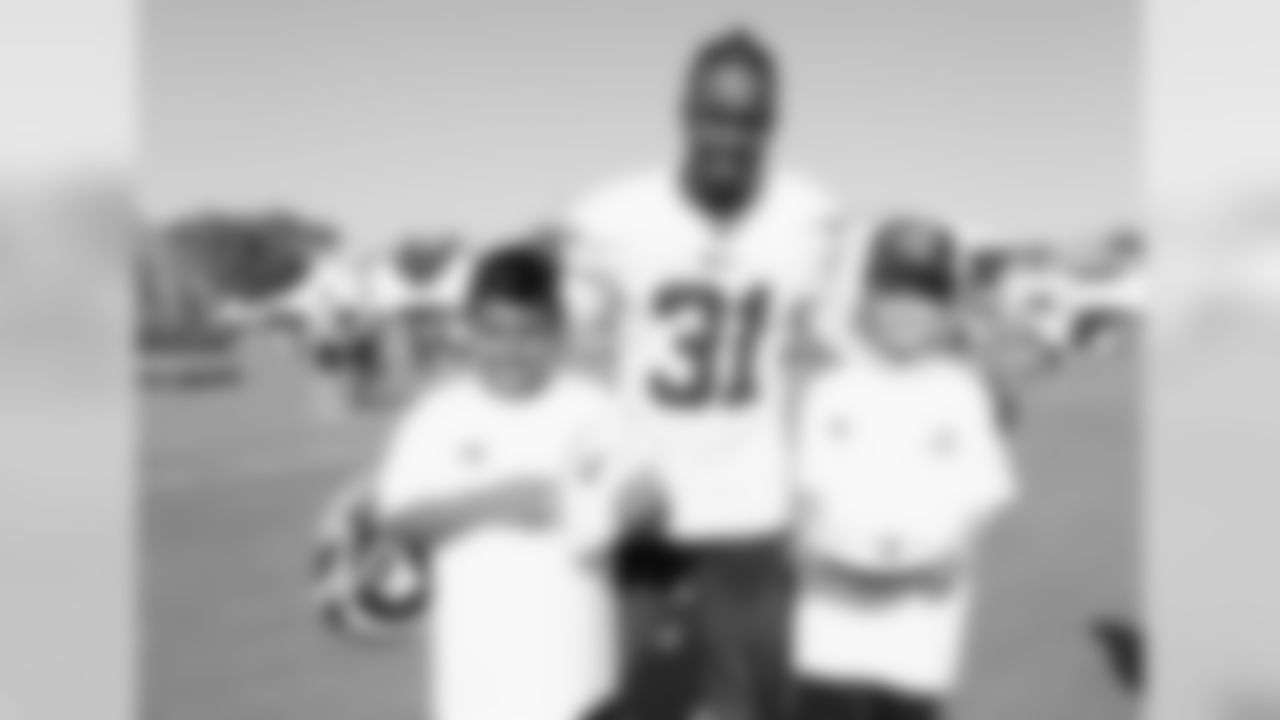 Cornerback (31) Taurean Nixon of the Los Angeles Rams poses for a photo with a fan during Day 3 of Training Camp, Saturday, July 28, 2018, in Irvine, CA. (Will Navarro/Rams)