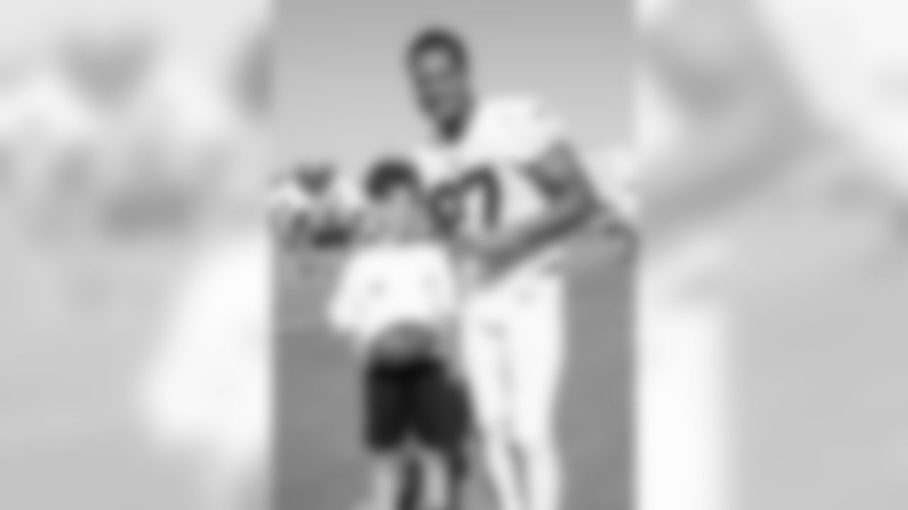 Defensive back (27) Isaiah Johnson of the Los Angeles Rams poses for a photo with a fan during Day 3 of Training Camp, Saturday, July 28, 2018, in Irvine, CA. (Will Navarro/Rams)