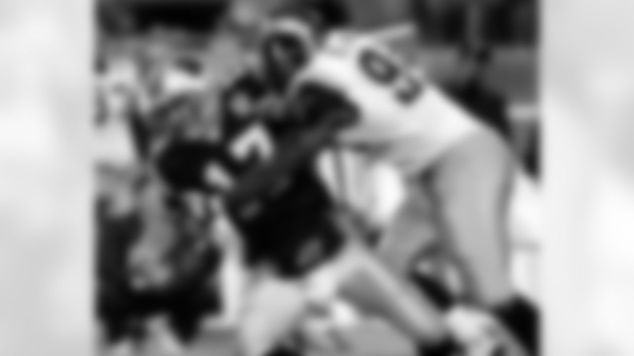 Carolina Panthers quarterback Jake Delhomme (17) loses the ball as he is sacked by St. Louis Rams' Bryce Fisher (94) during the second quarter in Charlotte, N.C., Sunday Dec. 12, 2004. The Panthers recovered the ball.(AP Photo/Chuck Burton)