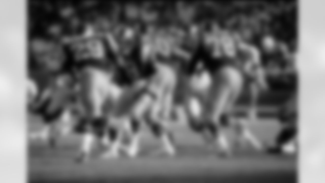 Los Angeles Rams quarterback Steve Dils (8) hands off to Hall of Fame running back Eric Dickerson (29) while Hall of Fame tackle Jackie Slater (78) leads the blocking during a 14-7 victory over the Atlanta Falcons on October 26, 1986, at Anaheim Stadium i (AP Photo/NFL Photos)