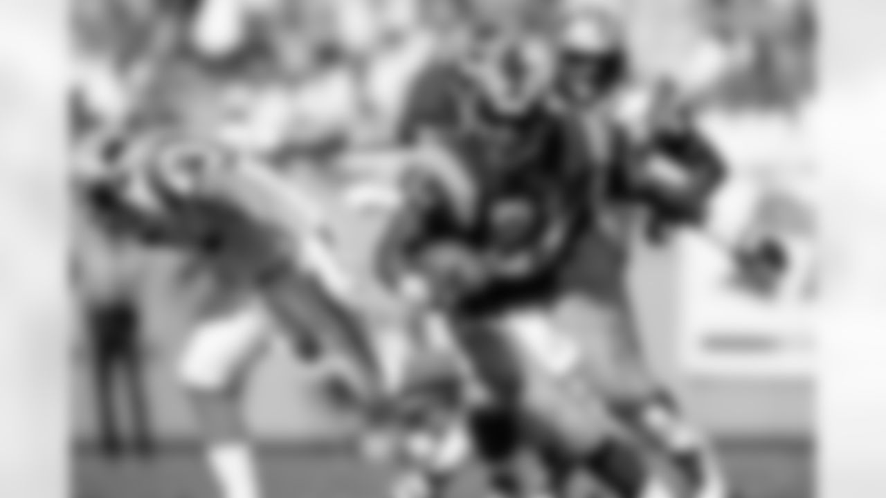 St. Louis Rams running back Lawrence Phillips (21) rushes upfield during an NFL game against the Carolina Panthers Oct. 13, 1996, in Charlotte, N.C. The Panthers defeated the Rams 45–13. (Allen Kee via AP)