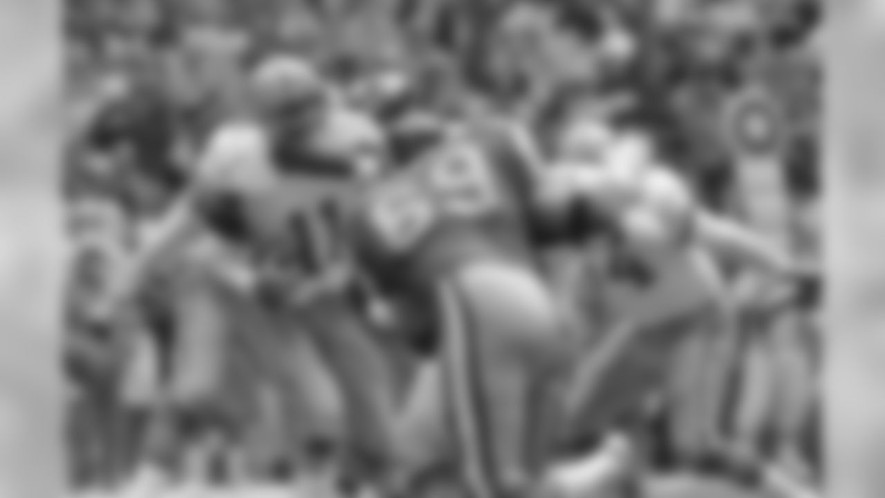 Dallas Cowboys quarterback Danny White (11) is sacked by the Los Angeles Rams defense for a 13-yard loss during second quarter action in Irving, Texas on Monday, Dec. 26, 1983. Ram in foreground is Greg Meisner (69). (AP Photo/Mike Murphy)