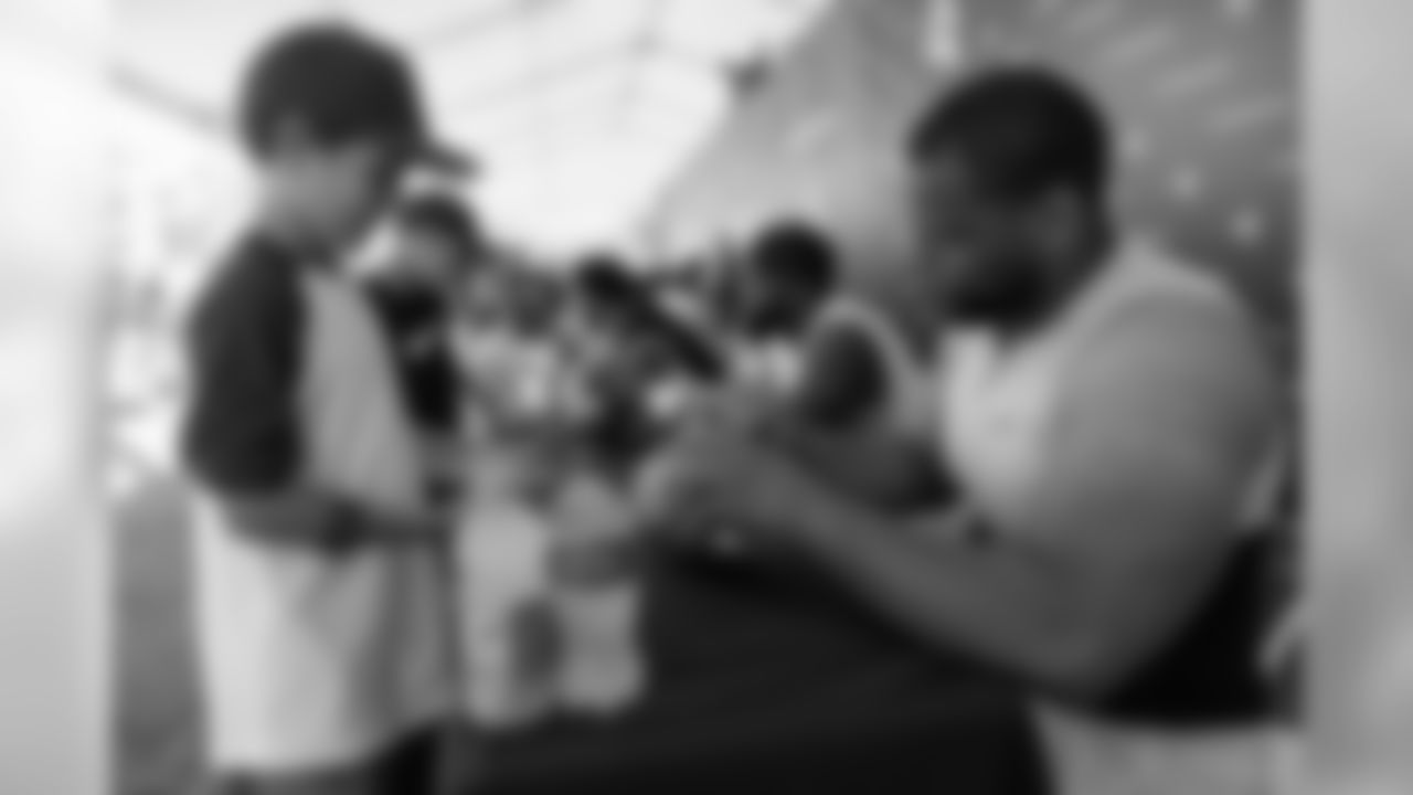 Defensive tackle (93) Ndamukong Suh of the Los Angeles Rams signs autographs during Day 5 of Training Camp, Monday, July 30, 2018, in Irvine, CA. (Will Navarro/Rams)