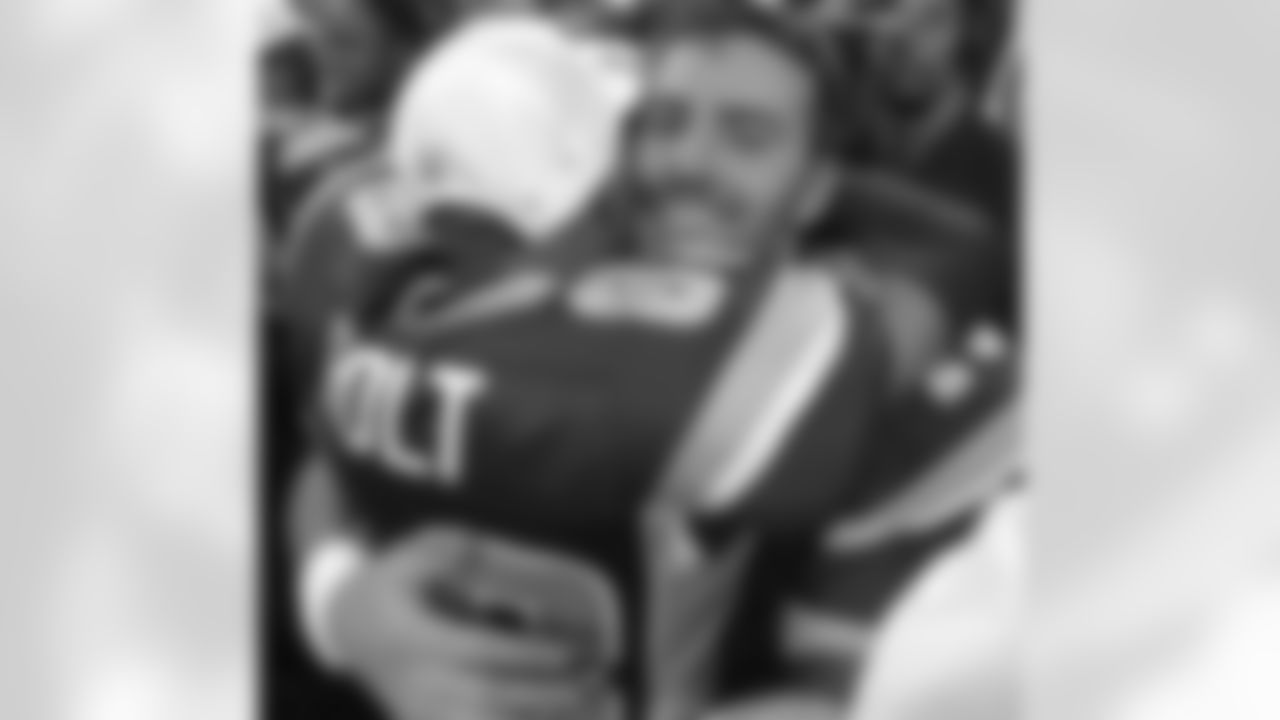 St. Louis Rams quarterback Kurt Warner, right, smiles as he hugs teammate Torry Holt after the Rams beat the Philadelphia Eagles 29-24 in the NFC Championship game in St. Louis, Sunday, Jan. 27, 2002. (AP Photo/Morry Gash)