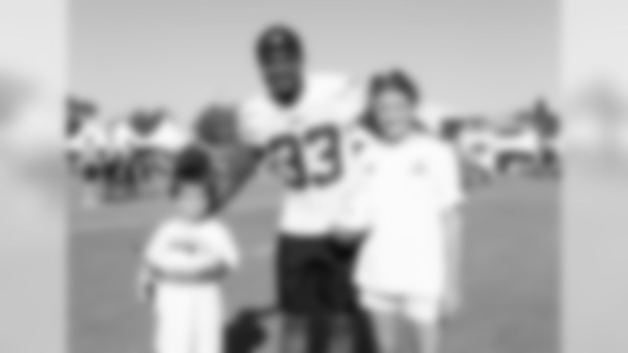 Defensive back (33) Curtis Mikesell of the Los Angeles Rams poses for a photo with a fan during Day 3 of Training Camp, Saturday, July 28, 2018, in Irvine, CA. (Will Navarro/Rams)