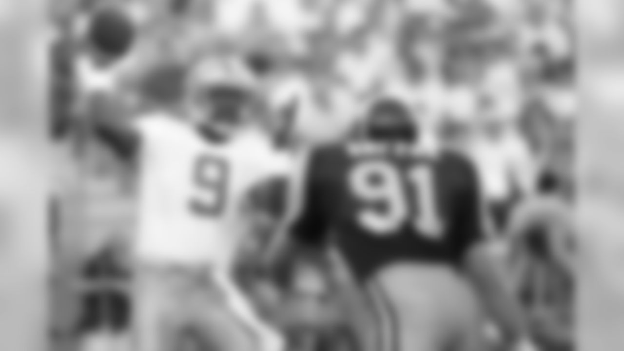 Detroit Lions quarterback Rodney Peete (9), formerly of USC, looks for an open receiver under pressure by Los Angeles Rams linebacker Kevin Greene in the first quarter at Anaheim Stadium, Sept. 2, 1989. (AP Photo/Doug Pizac)