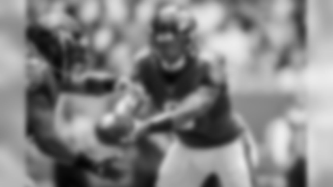 Quarterback Lamar Jackson hands off the ball in the first regular season game against the Miami Dolphins on September 8, 2019.