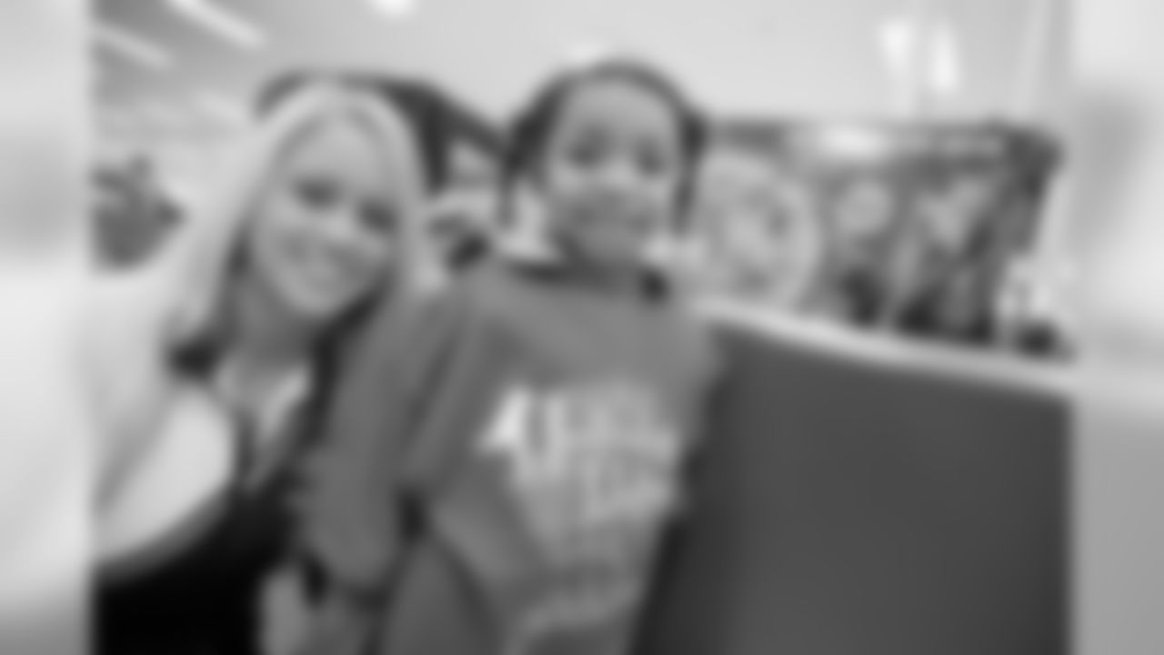 Baltimore Ravens players and cheerleaders go shopping with Baltimore-area youth at the Pikesville Target for the 4th Annual Holiday Helpers in December 2008.