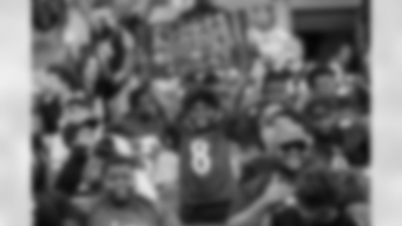 A young Ravens fan holds up a sign.