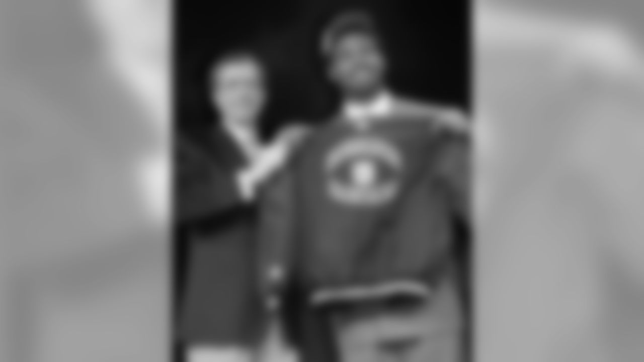 UCLA tackle Jonathan Ogden holds a Baltimore Ravens jacket with NFL Commissioner Paul Tagliabue after being selected fourth in the NFL draft in New York Saturday, April 20, 1996. (AP Photo/Wally Santana)
