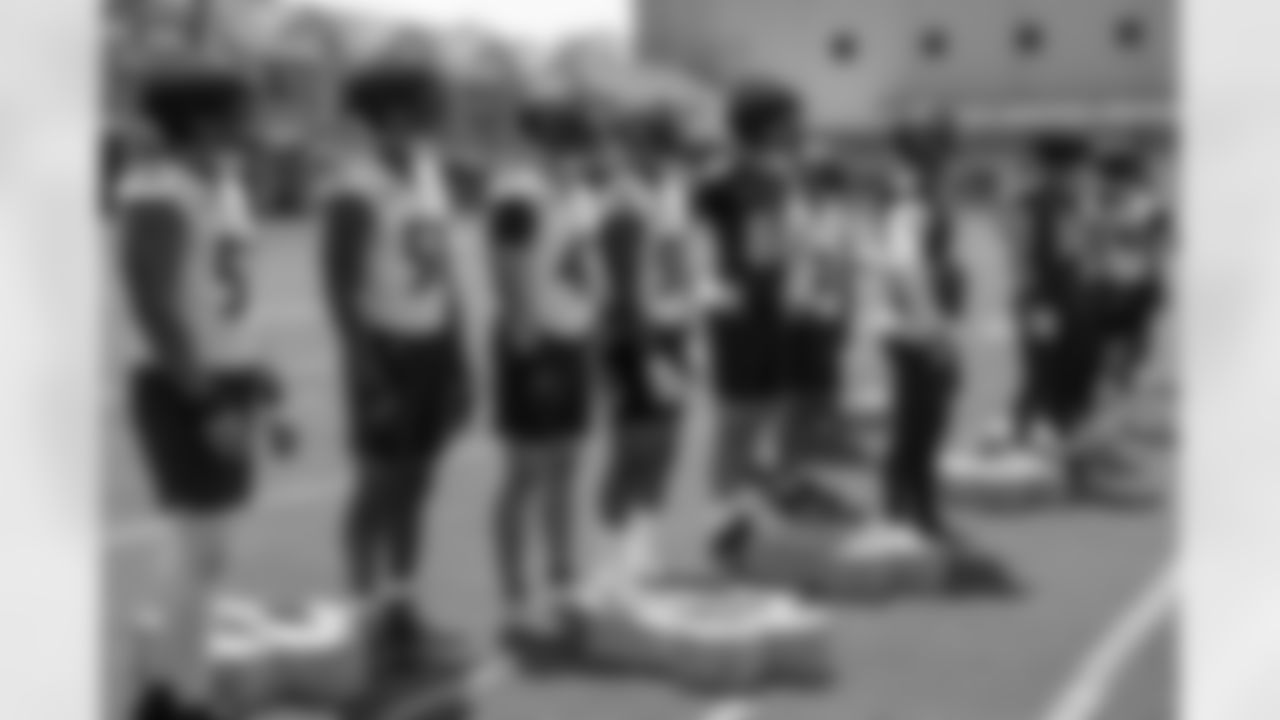 Players listen to instruction before a special teams drill