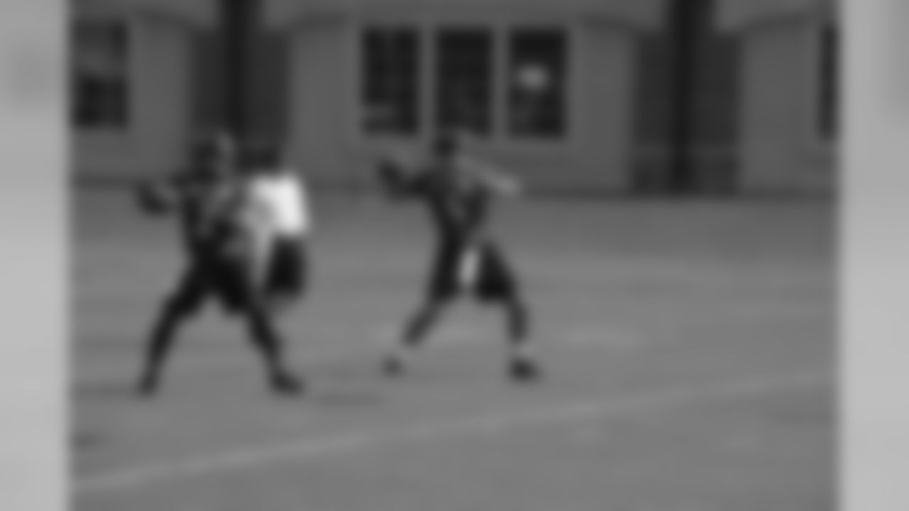 Joe Flacco and Tyrod Taylor participate in a drill at training camp.