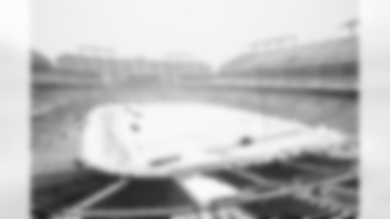 Workers attempt to clear snow from M&T Bank Stadium as a snowstorm bears down on the Baltimore area. The snow delayed the start of Sunday's game against the Chicago Bears from 1 p.m. to 4:15 p.m. and held up the Bears' flight to Baltimore.