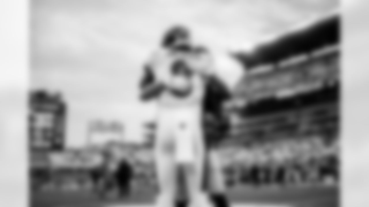 QB Lamar Jackson (8) embraces an opponent before a game against the Pittsburgh Steelers at Heinz Field on December 5, 2021.