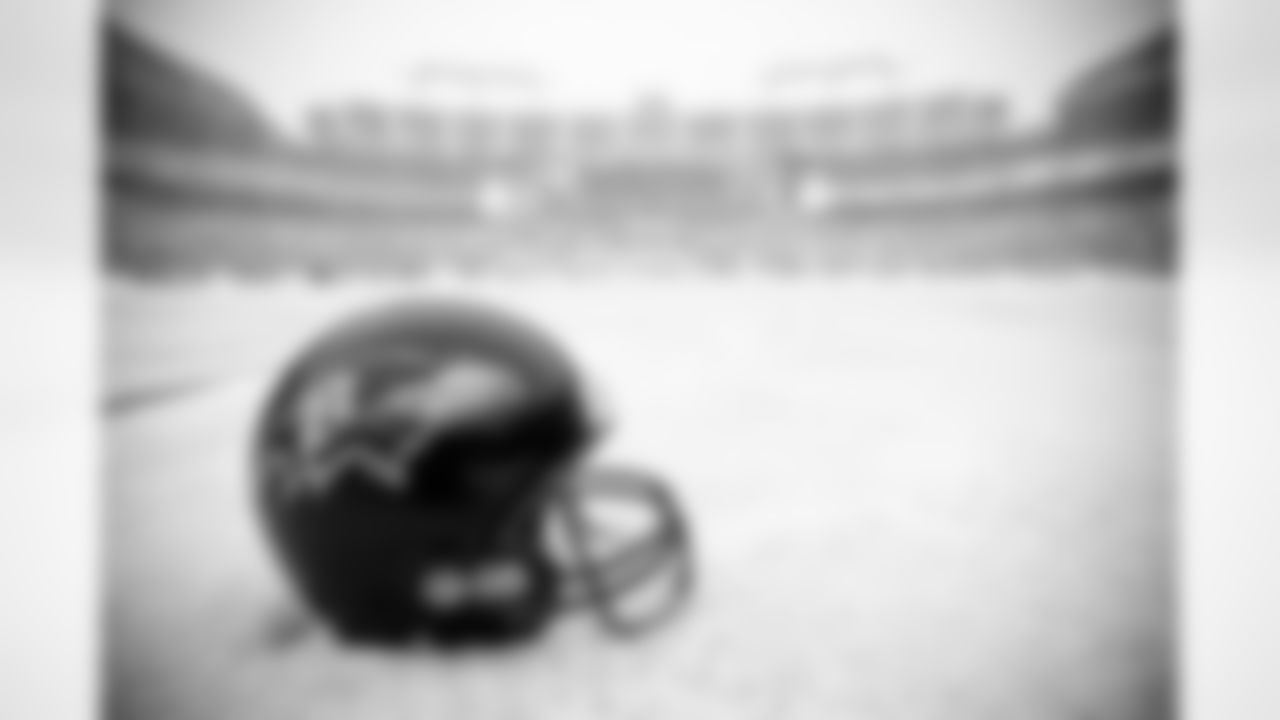 Workers attempt to clear snow from M&T Bank Stadium as a snowstorm bears down on the Baltimore area. The snow delayed the start of Sunday's game against the Chicago Bears from 1 p.m. to 4:15 p.m. and held up the Bears' flight to Baltimore.