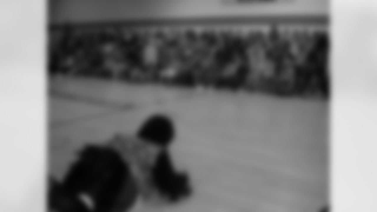Ravens players and cheerleaders visit local schools to encourage students to be active as part of the "What Moves U" program.